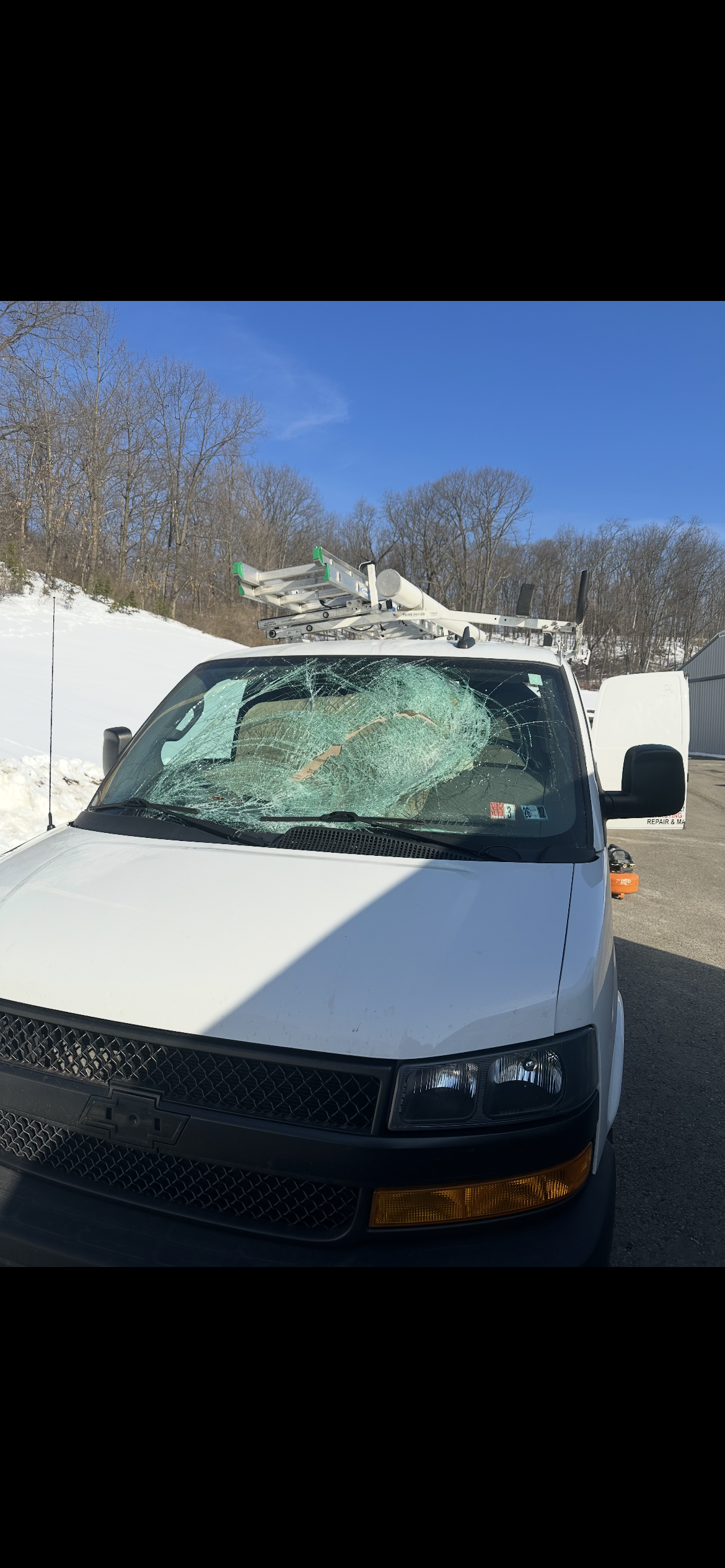 Shattered windshield — white work van